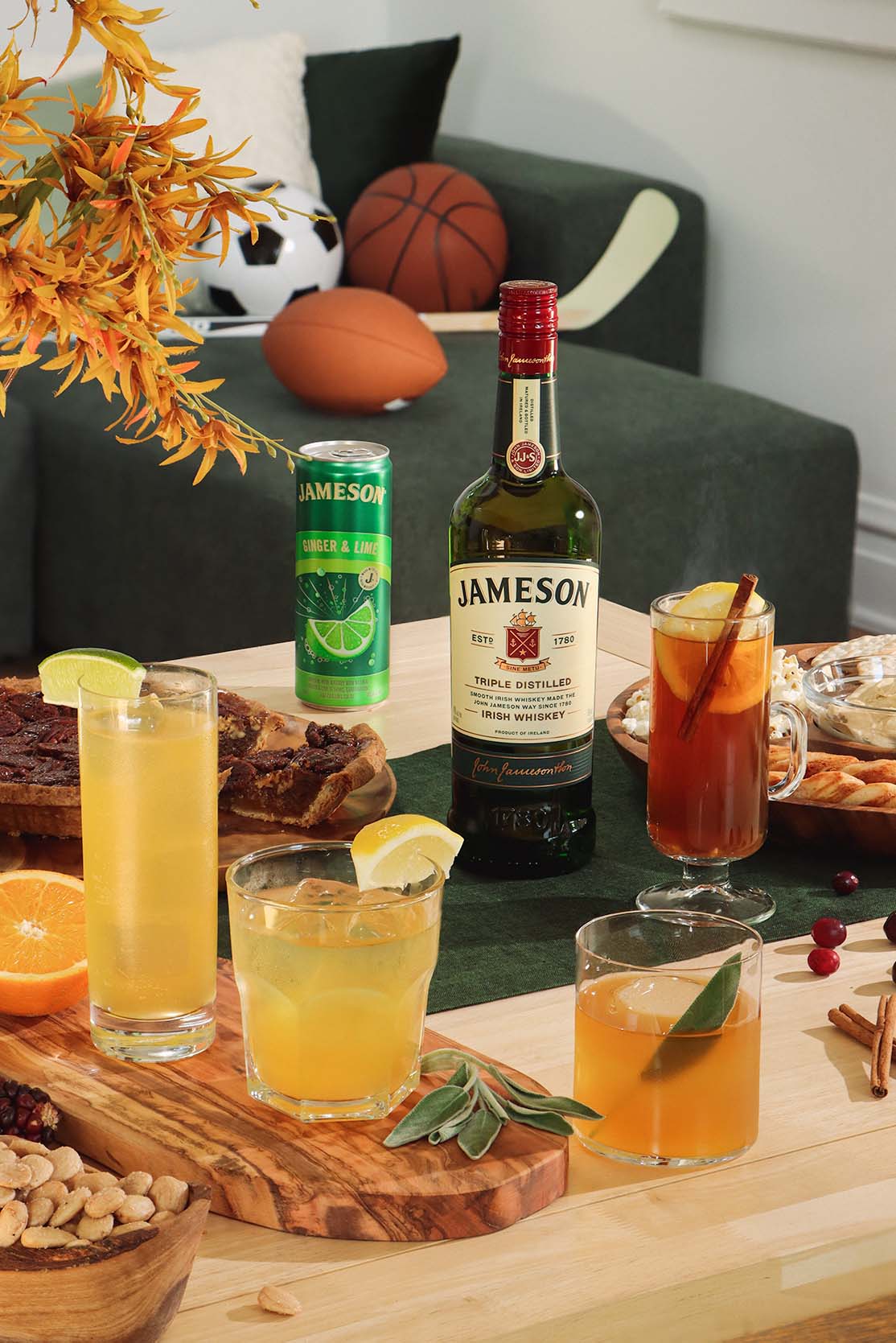 4 unique cocktails and the Jameson Original bottles surrounded by sports props.