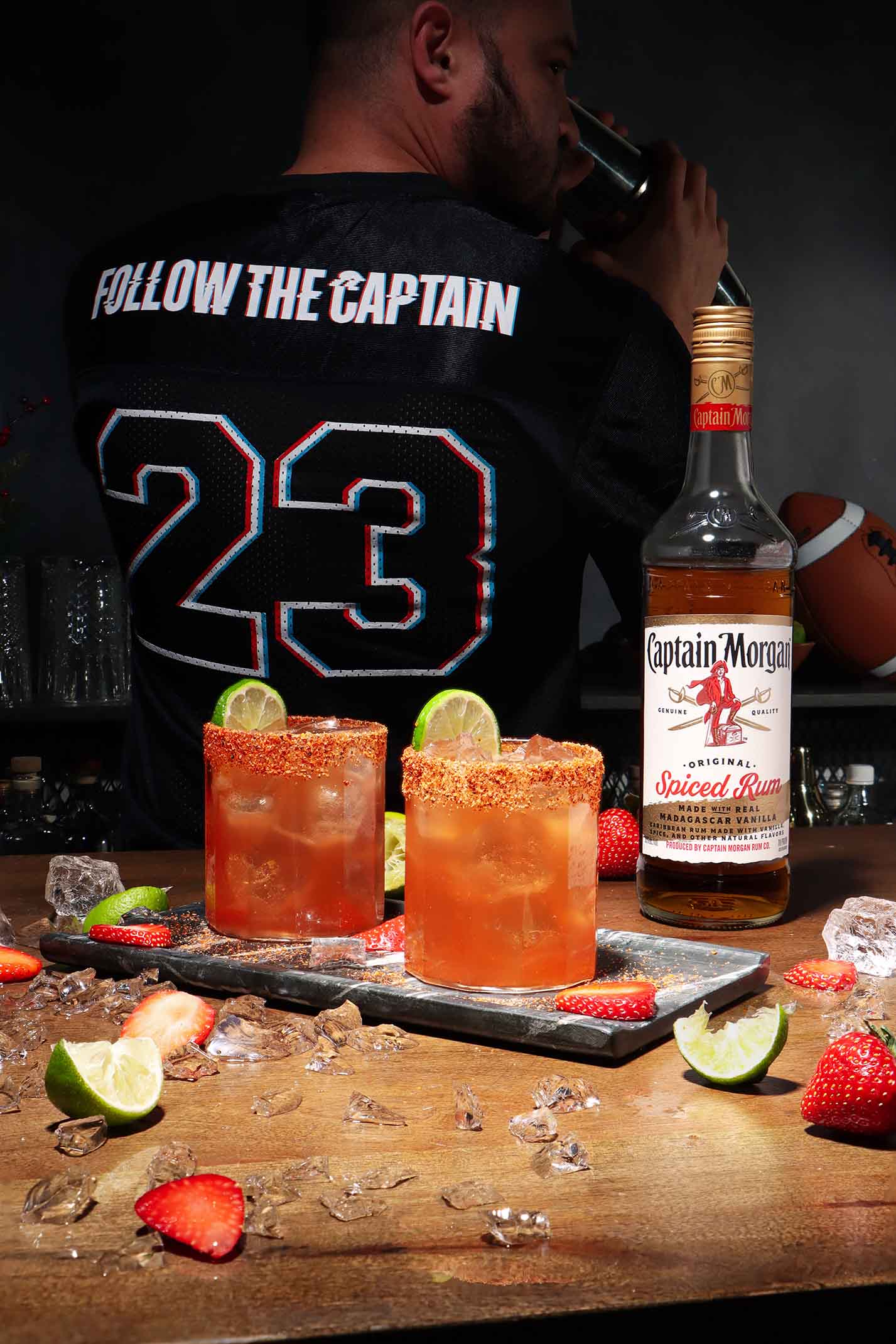 Captain Morgan bottle with Strawberry Rumrita cocktail and jersey.