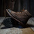 Pair of Harlow boots, one standing upright and the other showing the bottom view to highlight the durable molded rubber outsole and handcrafted leather midsole for added comfort and support