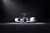 Symmetric front-profile of a modern delivery drone positioned within a high-contrast, dark-lit studio for product showcase.