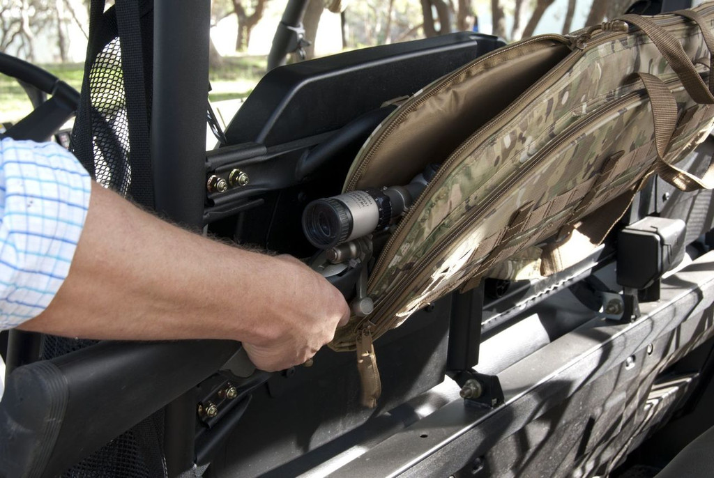 Gun being pulled out of MultiCam® Scoped Rifle Case attached to a vehicle.