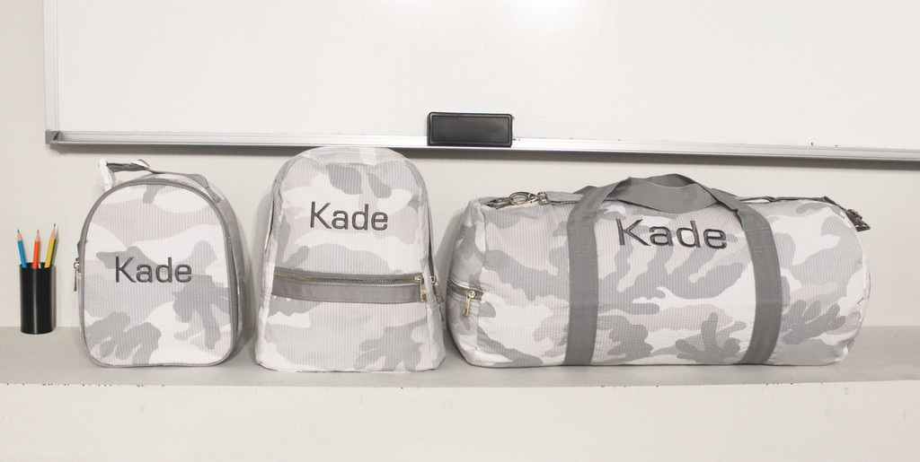 Snow Camo Backpack, Duffel, and Gumdrop Set with Kade monogrammed in dark grey letters.