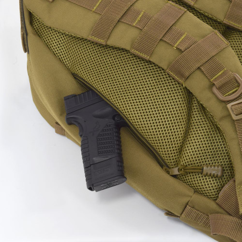 Two hidden backside pockets with zippers on both sides can be used as secure concealed carry compartments and for everyday carry essentials like wallet, keys, and knives.  Close up of pocket on Pecos Tactical Backpack in coyote brown with handgun inside.