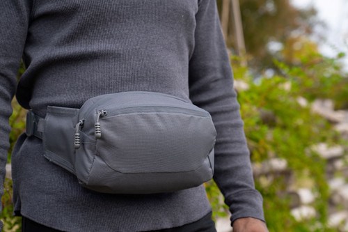 EDC Sling Bag & Waist Pack  in Gun Metal worn around waist.