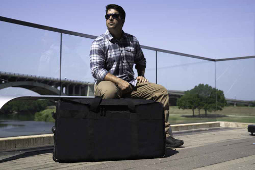 Black Buffalo Duffel shown laying on side outdoors.