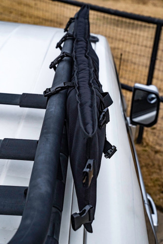 Black Shotgun Scabbard attached to black racks on top of a grey vehicle.