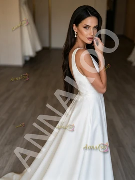 Back view of a simple satin A-line wedding dress showing the elegant train.
