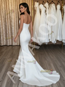 Low-back satin trumpet wedding dress showing the dramatic mermaid flare at the knee.