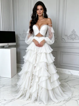 Front view of a white off the shoulder beaded cutout tulle prom dress featuring puffy sleeves and a full tiered ruffle skirt.