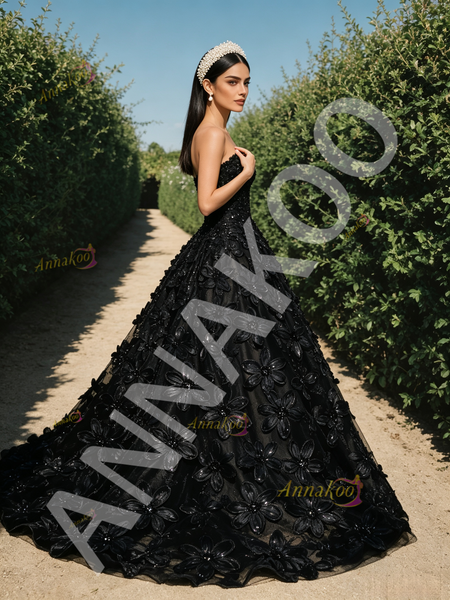 Black tulle A-line prom dress with a sweetheart neckline and intricate flower and sequin beading throughout the bodice and skirt.