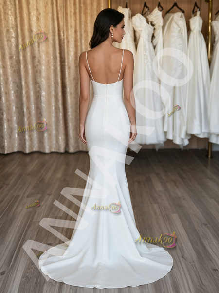 Low-back satin trumpet wedding dress showing the dramatic mermaid flare at the knee.