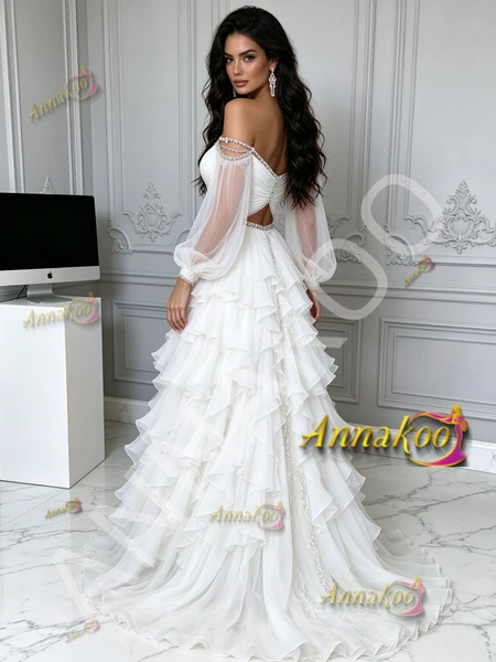 Side view showing the flowy tiered tulle skirt and detailed beaded bodice of the white formal prom dress.