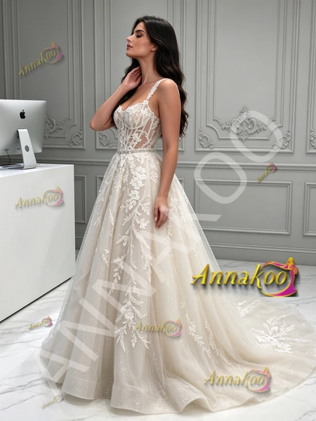 Full-length side profile of romantic A-line tulle bridal dress with spaghetti straps