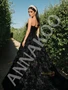 Back view of a custom-made black tulle prom gown showcasing the zipper closure and the flowing A-line silhouette.