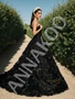 Black tulle A-line prom dress with a sweetheart neckline and intricate flower and sequin beading throughout the bodice and skirt.