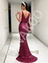 Back view of a fuchsia prom gown showcasing the backless design, the column silhouette, and the intricate beading.
