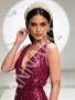 Close-up of the delicate beading and sequin embellishment on the bodice of a fuchsia V-neck prom dress.