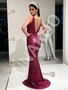 Back view of a fuchsia prom gown showcasing the backless design, the column silhouette, and the intricate beading.