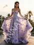 Side angle showcasing the sheer tulle foundation and the intricate floral placement cascading down.
