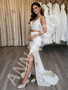 Bride holding the separate lace top and column skirt of her two-piece wedding dress