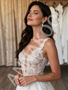 Close-up of intricate floral lace appliqués on the V-neck bodice of an A-line bridal gown