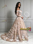 Side view of champagne off the shoulder bridal dress with detailed lace applique long sleeves