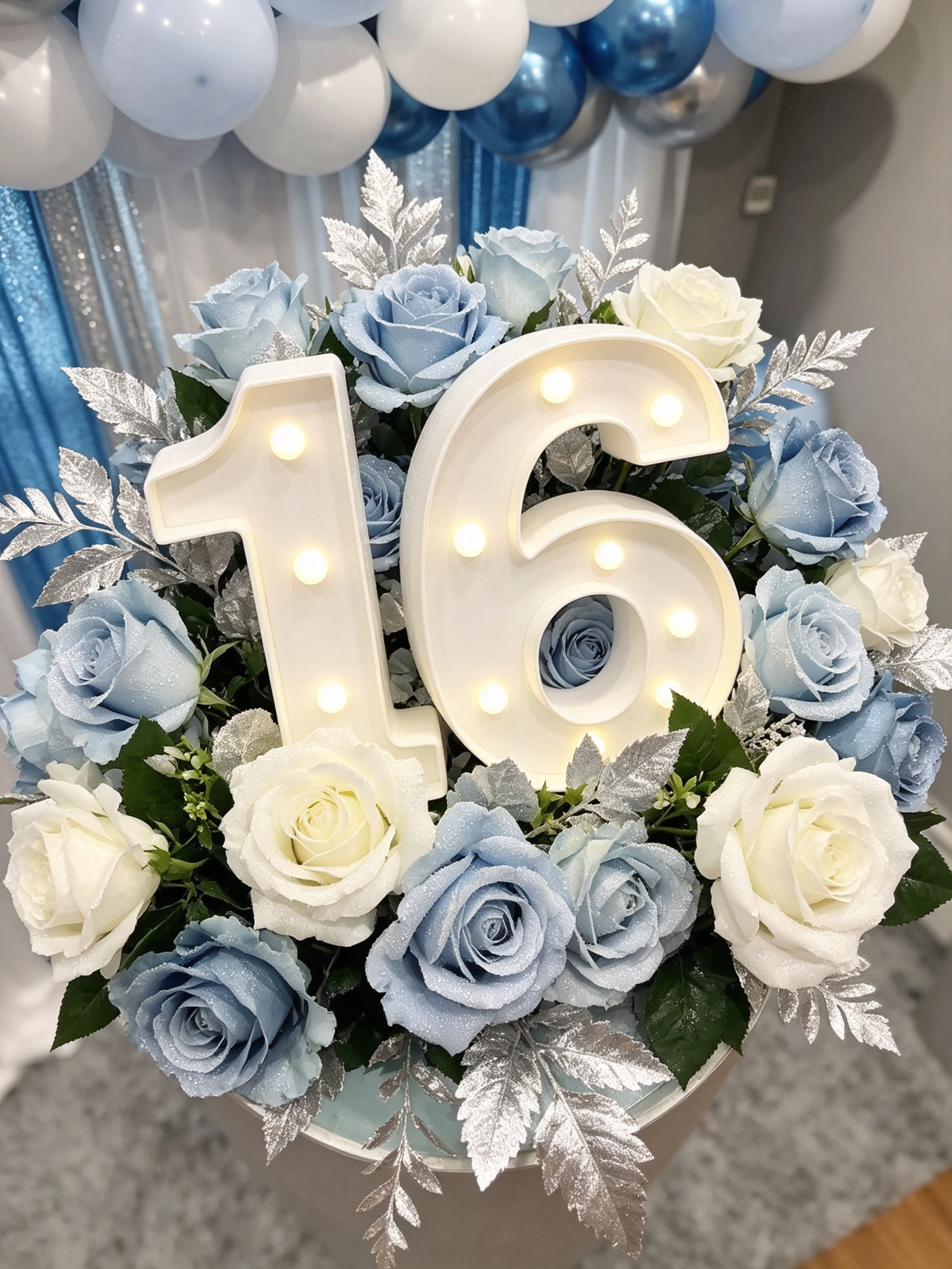 Sweet 16 marquee light surrounded by white and blue roses
