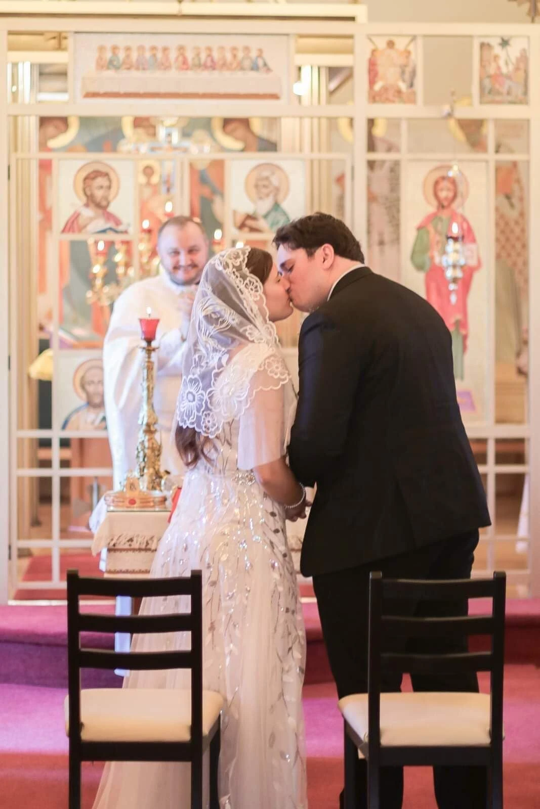 Tender wedding kiss during Lauren's October wedding ceremony