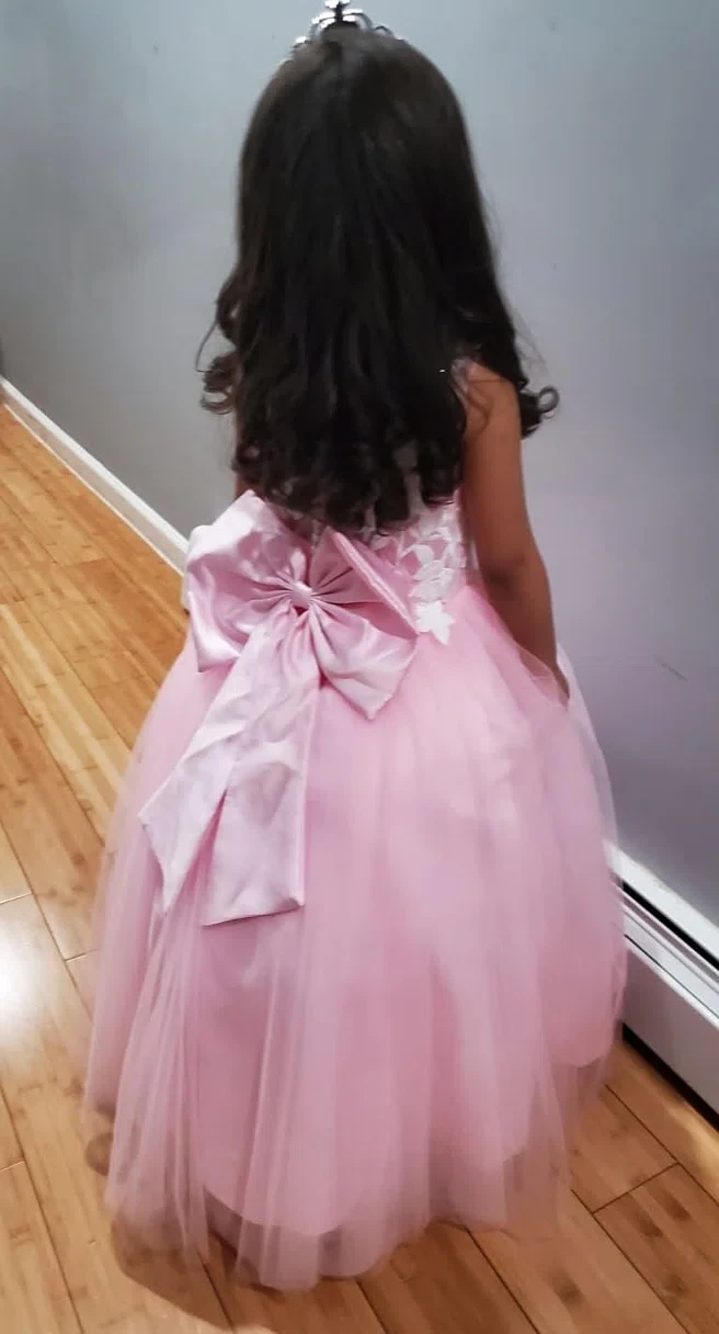 Back view of pink flower girl gown with large satin bow