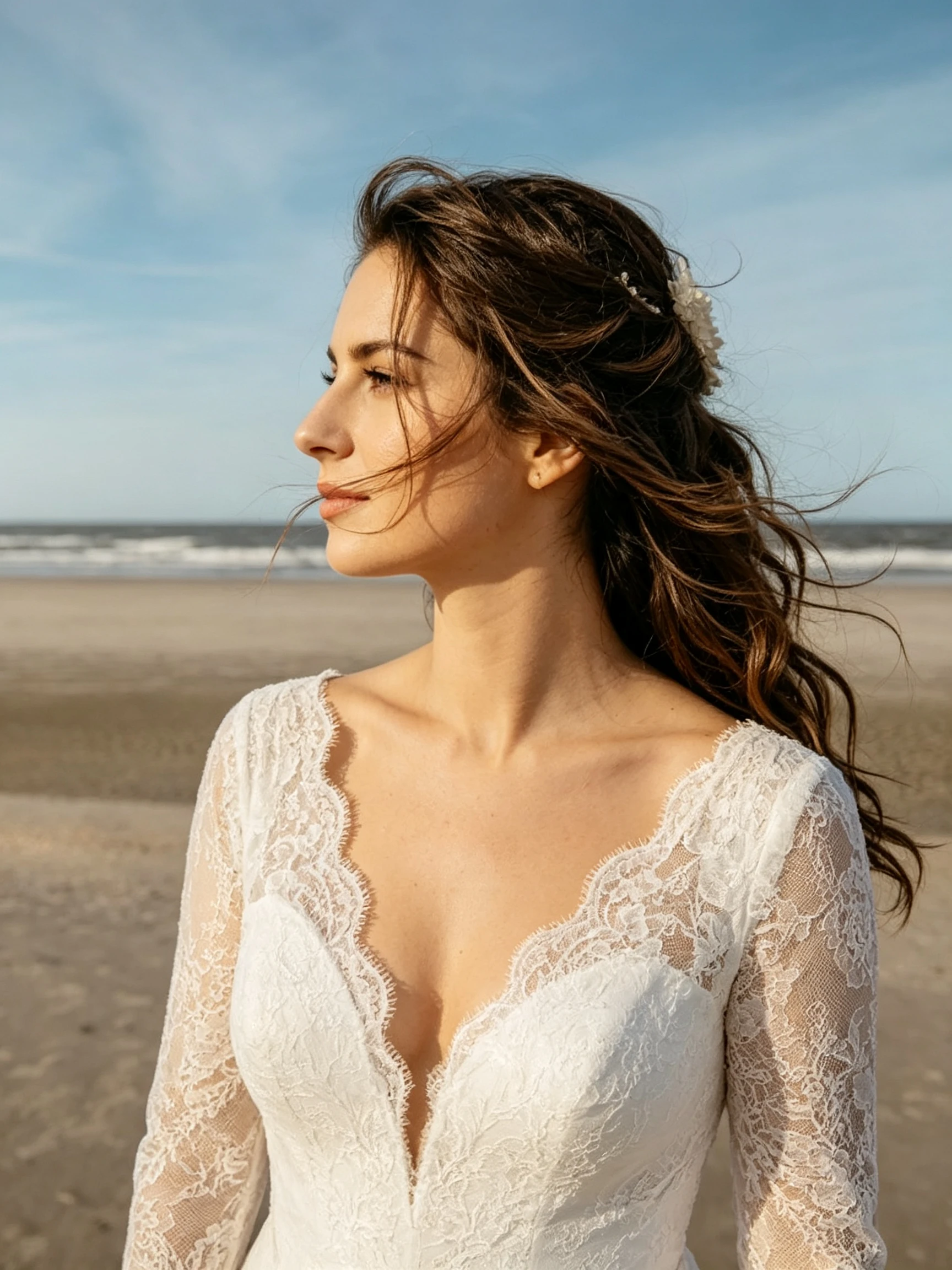 Bride profile portrait with ocean background in lace wedding dress
