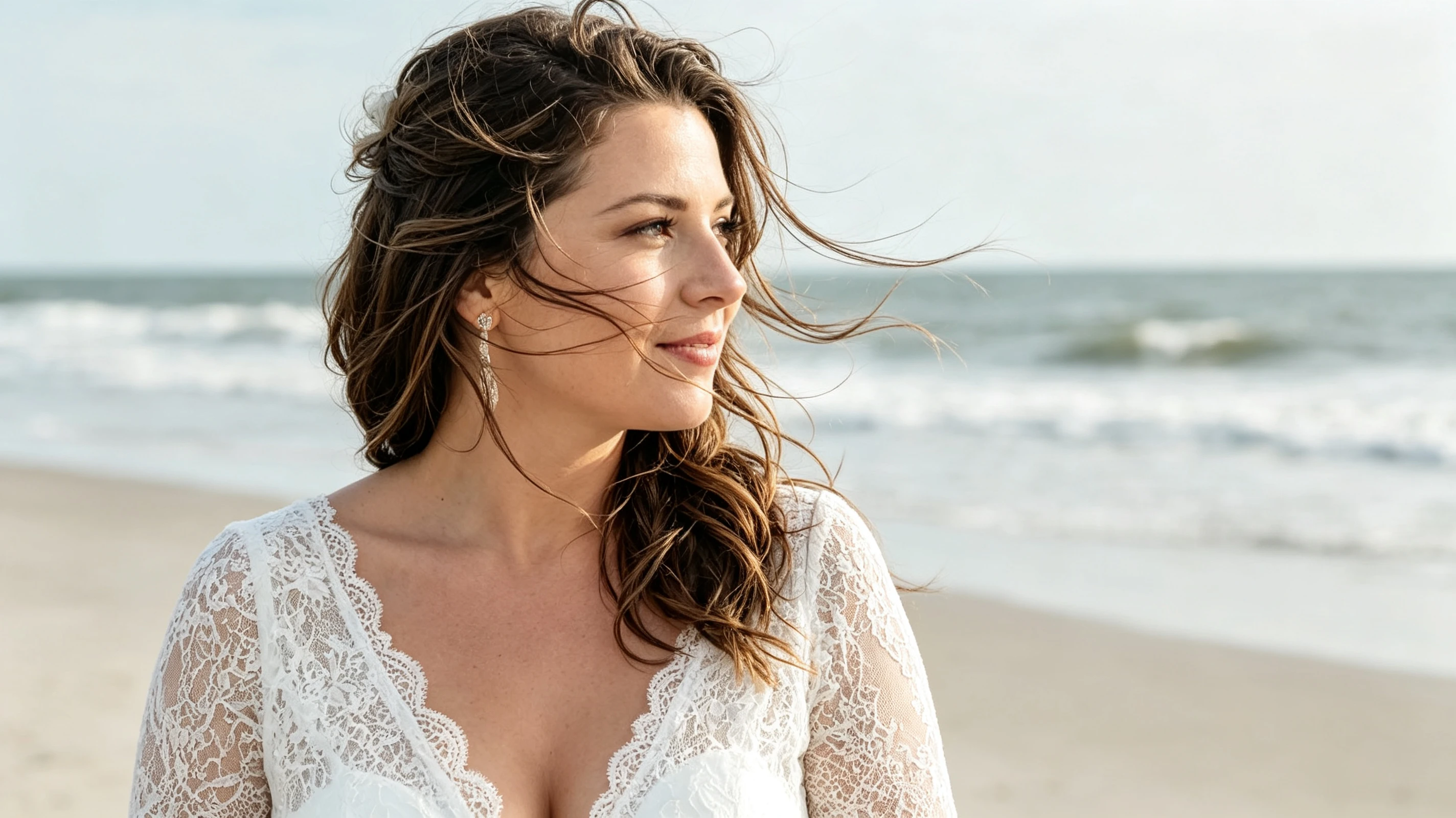 Bride profile with wind blown hair ocean background