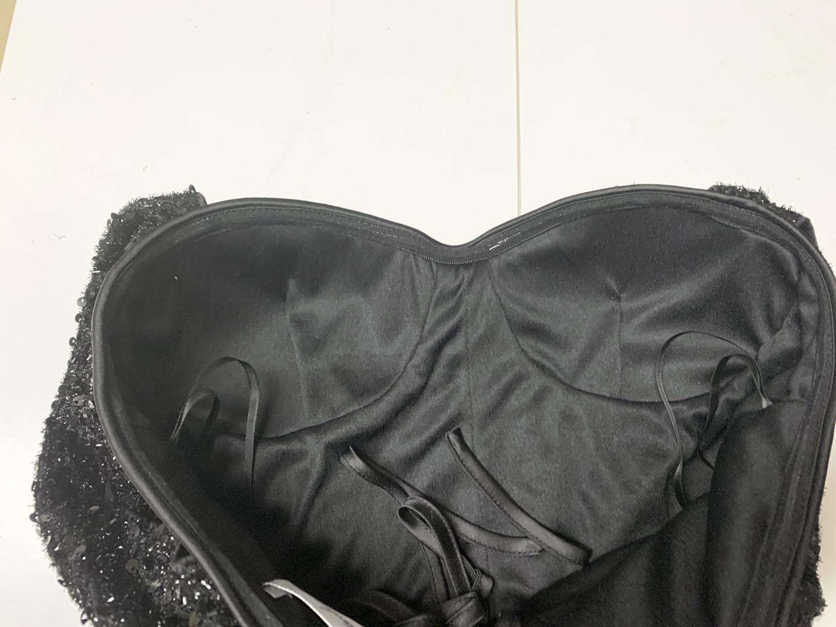 Inside view of the boned bodice construction in a black sequin formal dress