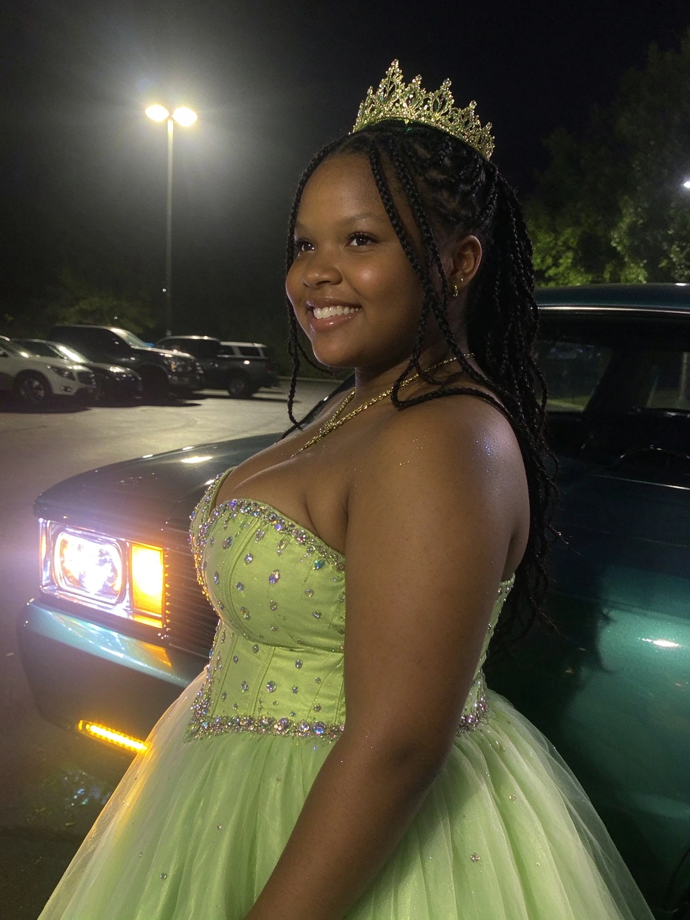 Side profile showing the fitted corset and voluminous lime green tulle skirt