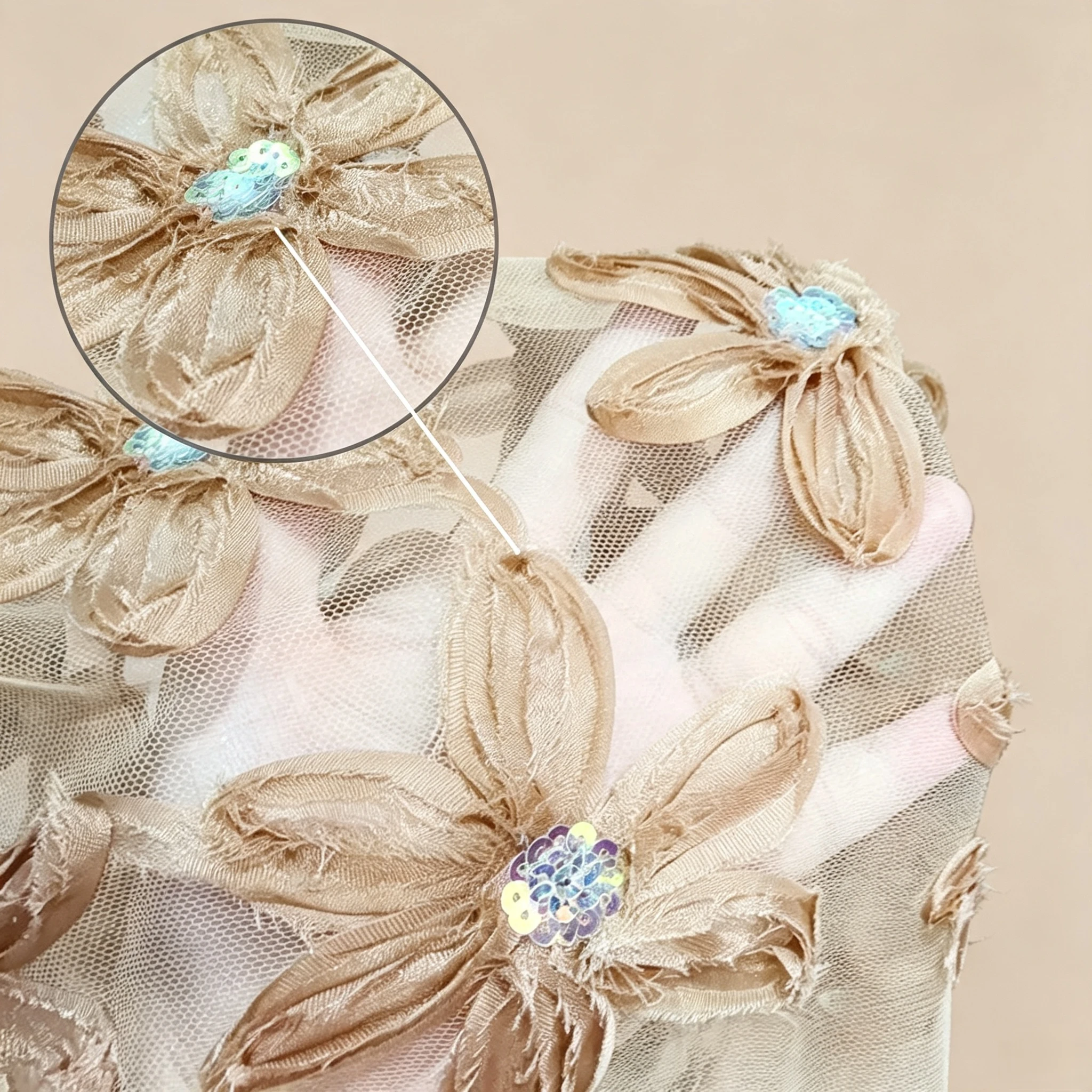 Champagne gold three dimensional floral lace on translucent nude tulle with satin ribbon petals and iridescent sequins