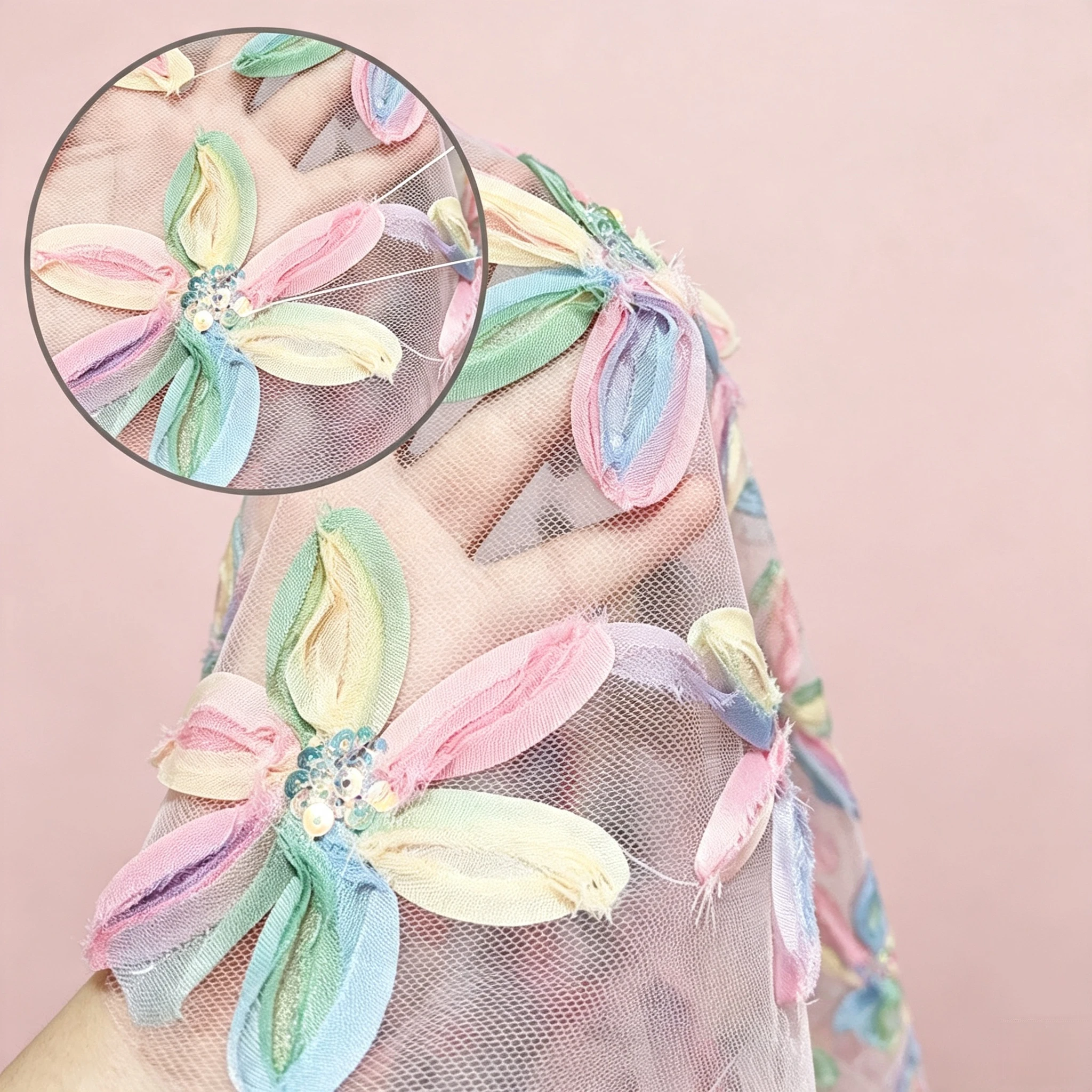 Close up of three dimensional pastel floral tulle with satin ribbon petals and iridescent sequin centers