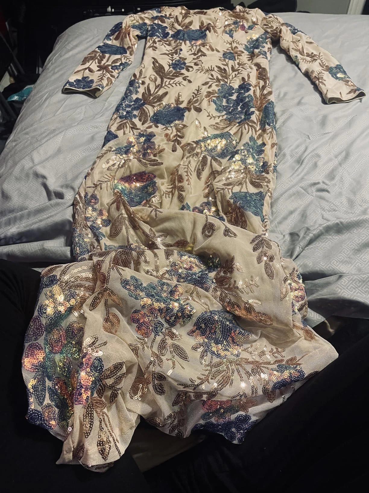 Flat lay showing champagne floral sequin formal gown and its detailed embellishment