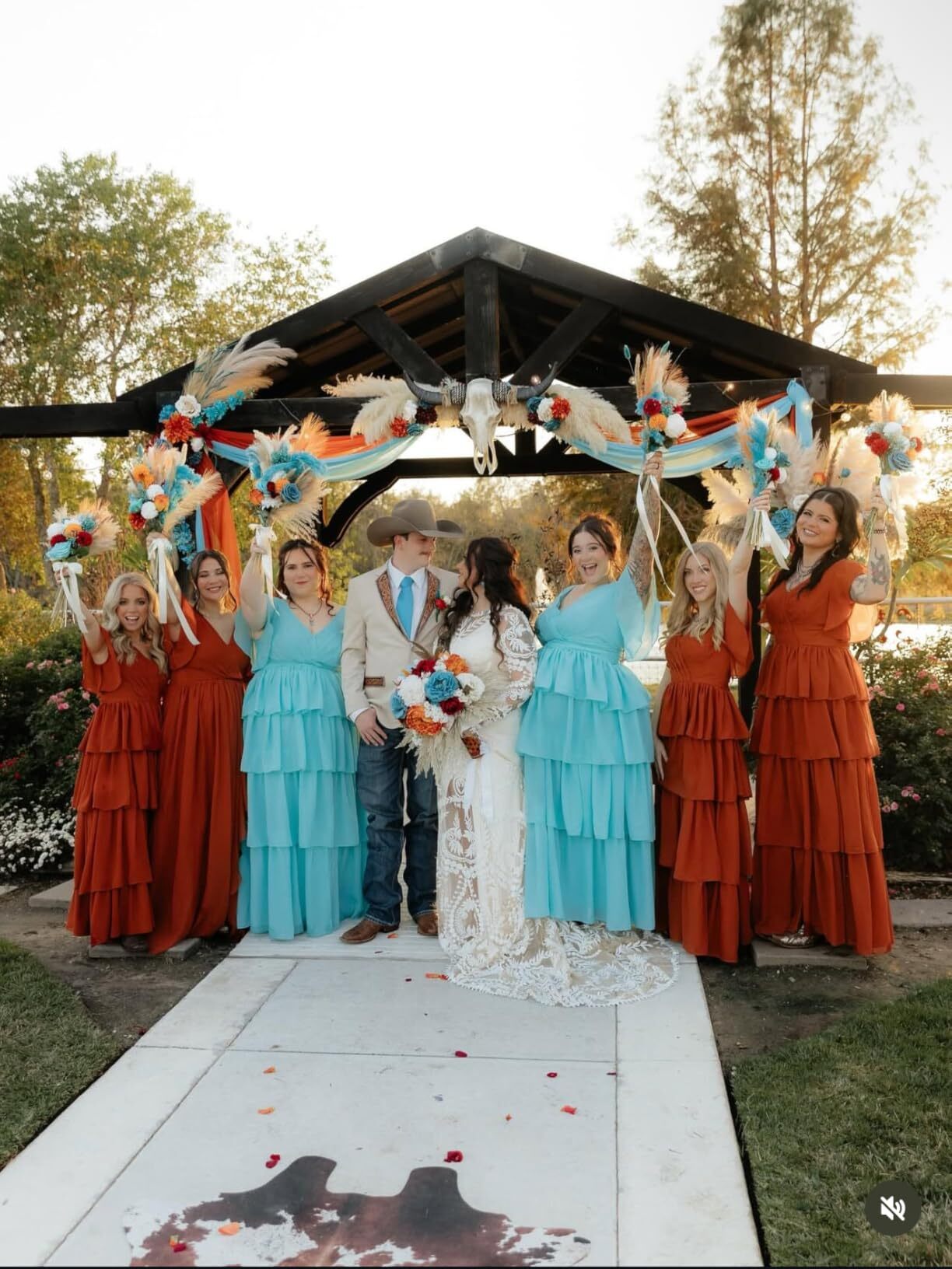Full bridal party with bride in long sleeve lace wedding dress