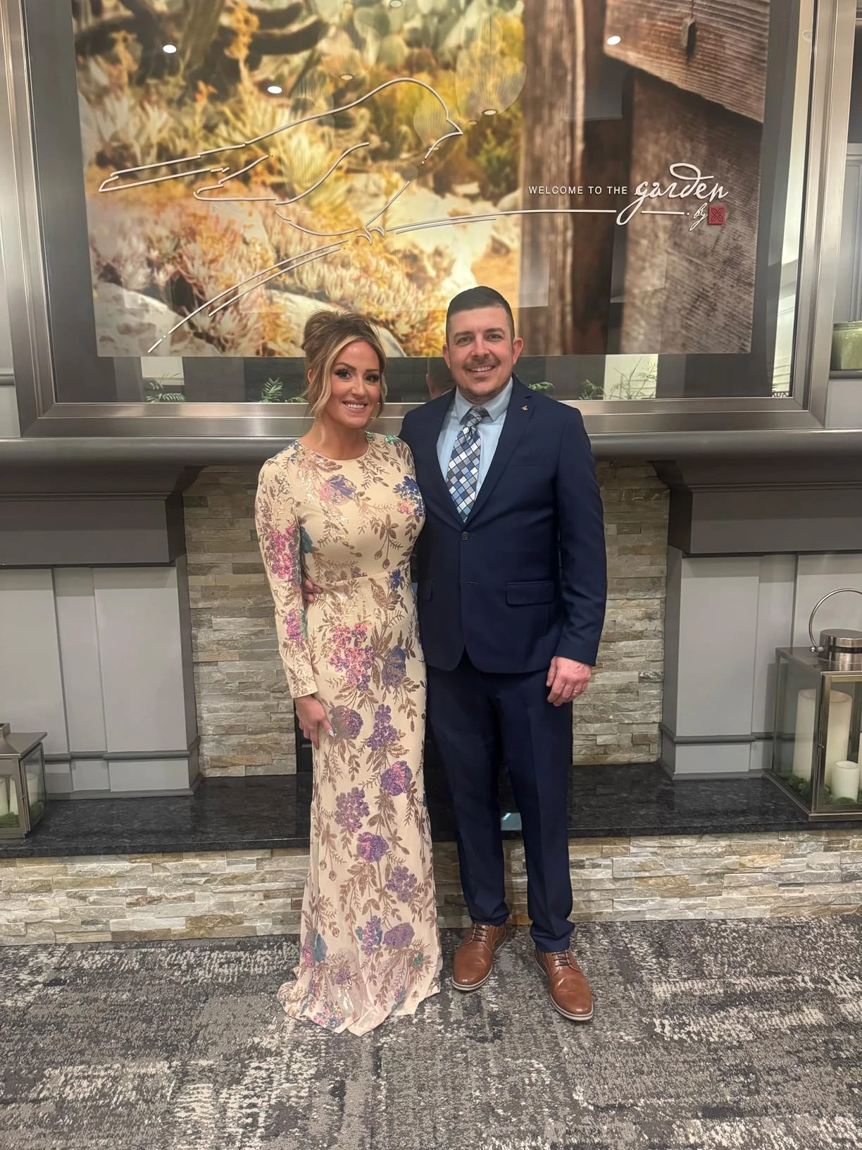 Couple portrait at a gala event with woman wearing a floral sequin evening gown