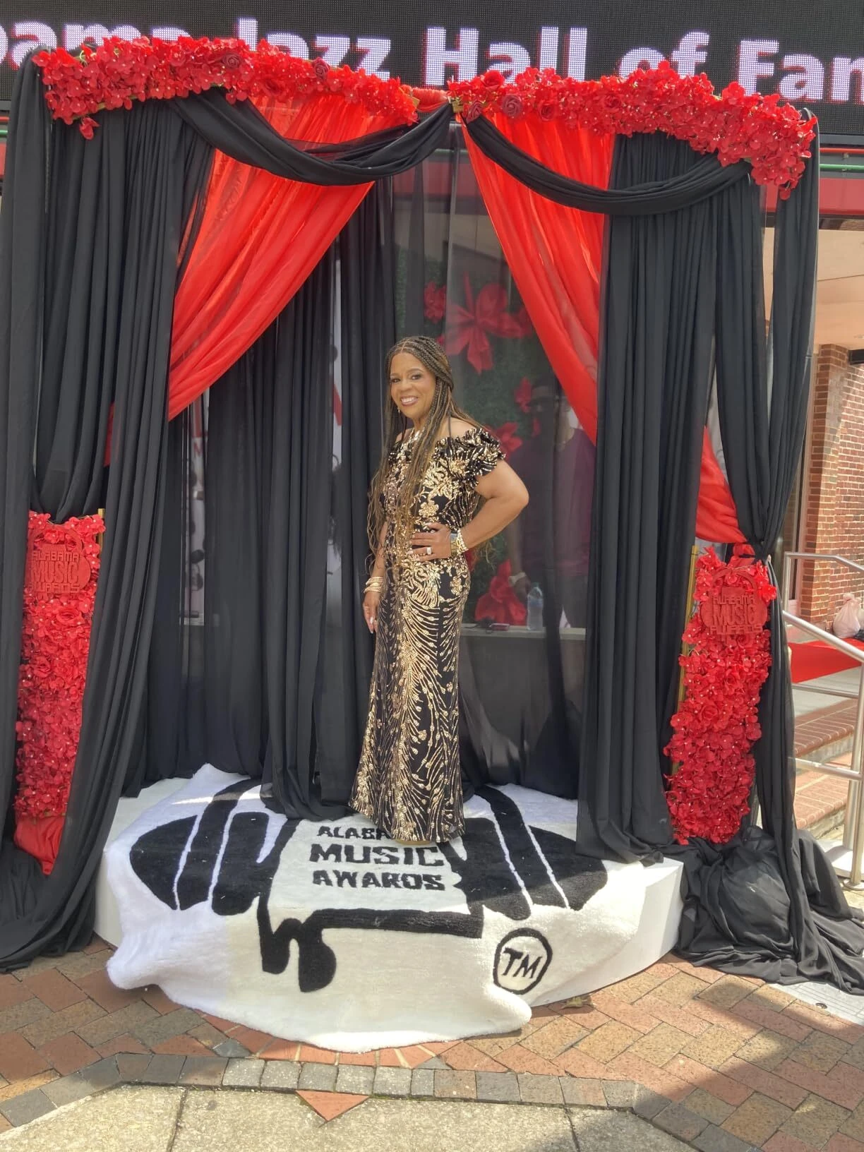 Glamorous black and gold sequin formal gown at awards photo backdrop