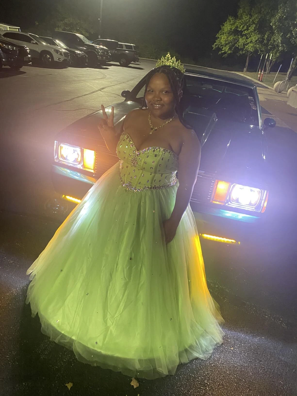 Glittering rhinestone lime green ball gown photographed under nighttime lighting