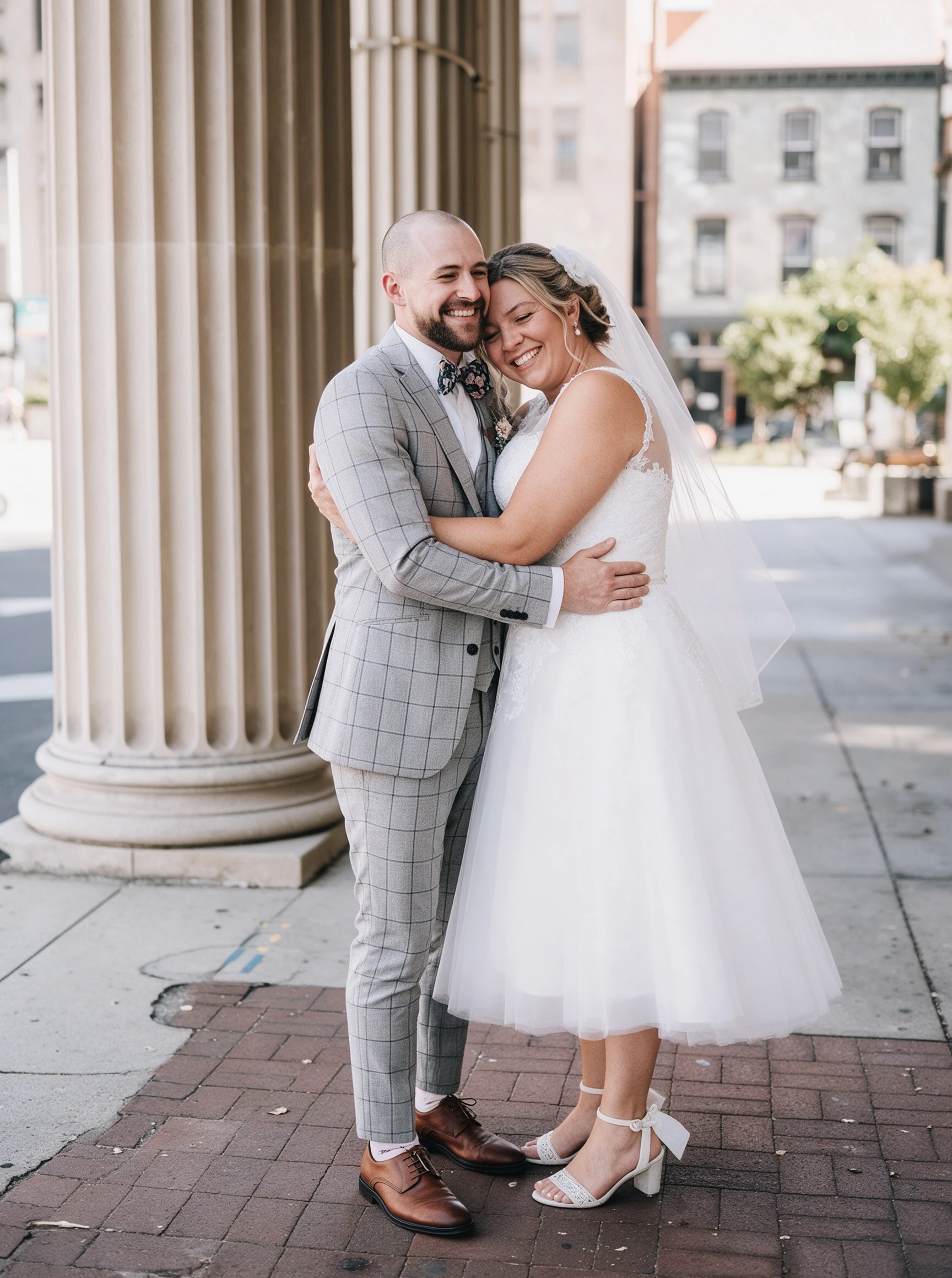 Hugging my groom in my short lace wedding dress