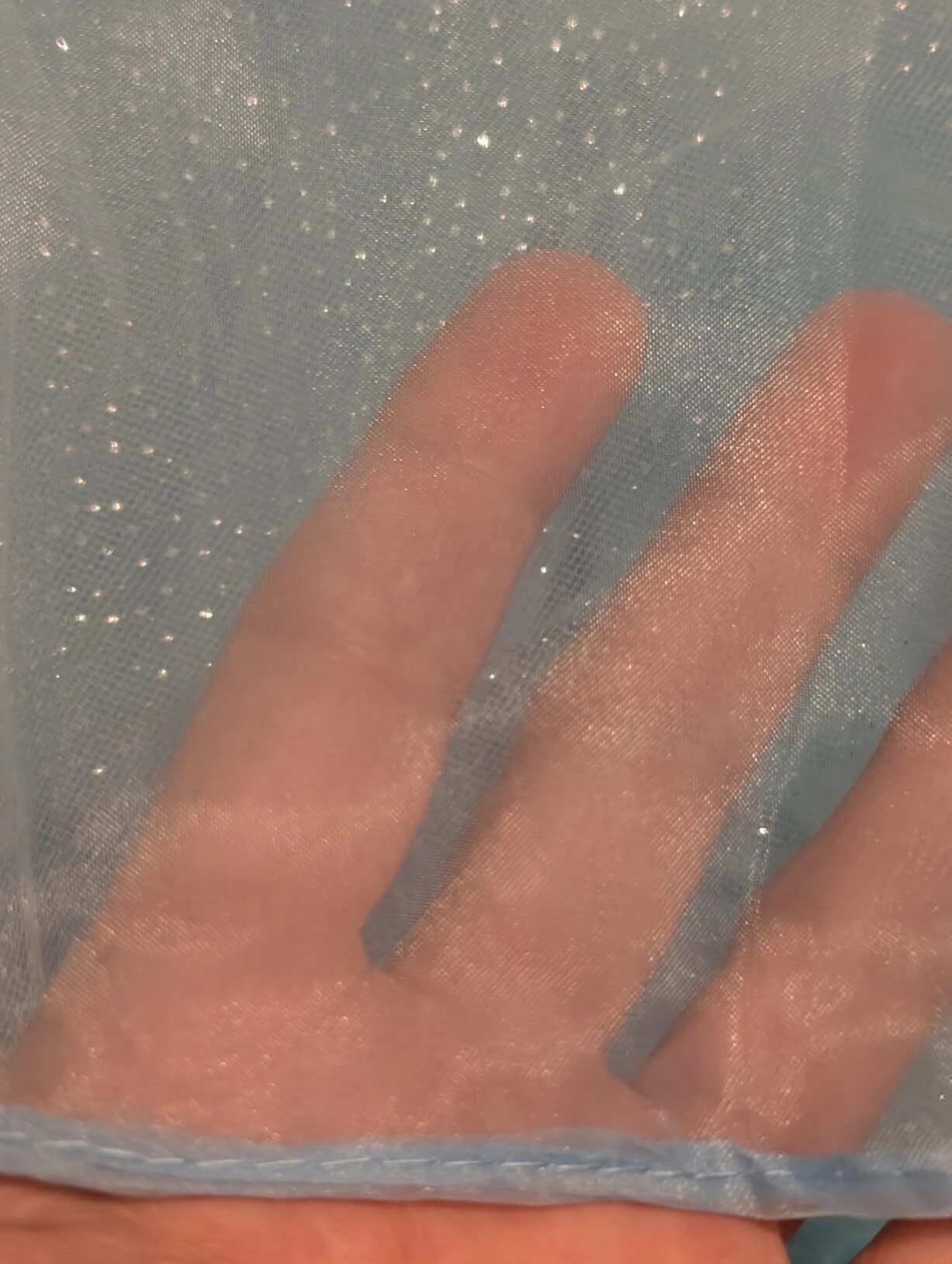 Soft light blue tulle fabric closeup