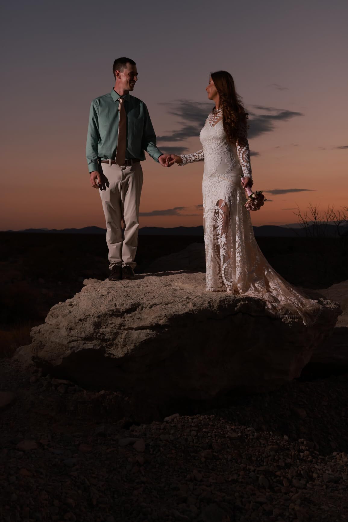 Long sleeve lace wedding dress during blue hour at a desert elopement