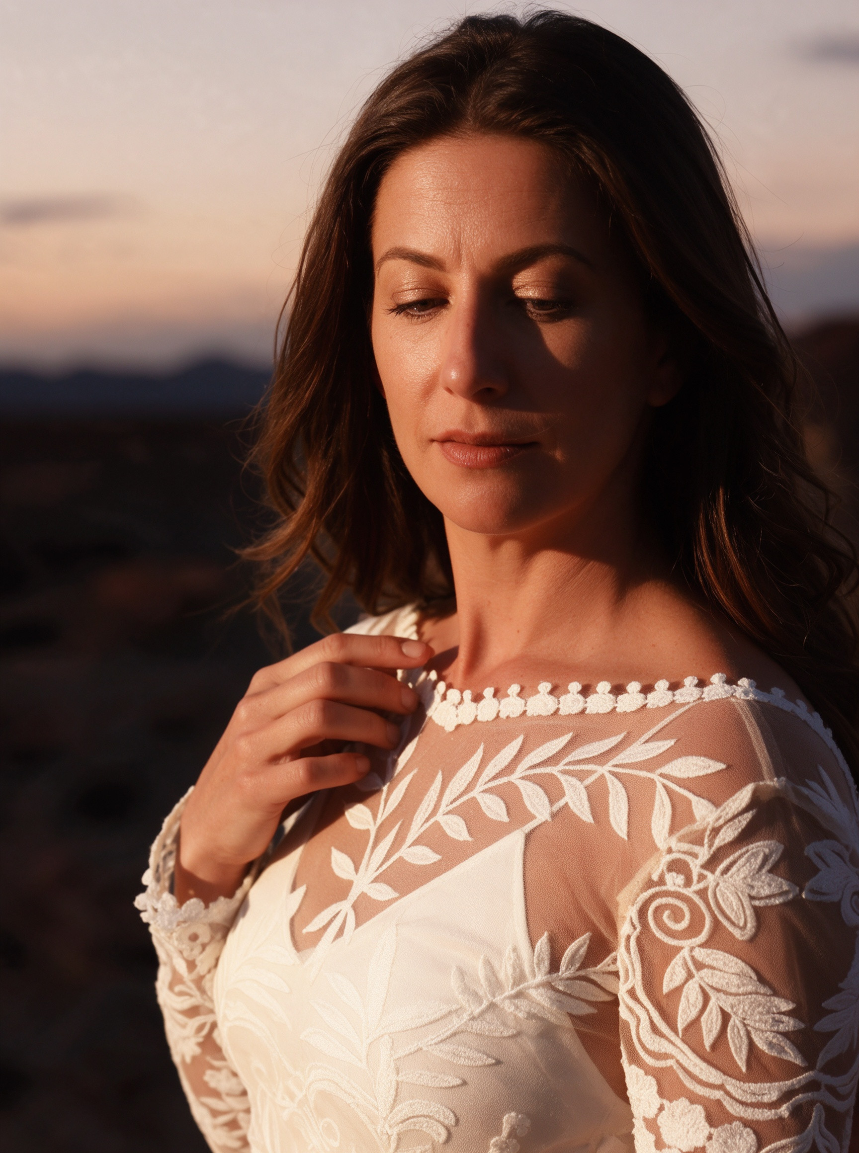 Long sleeve ivory lace wedding dress in warm desert sunset light