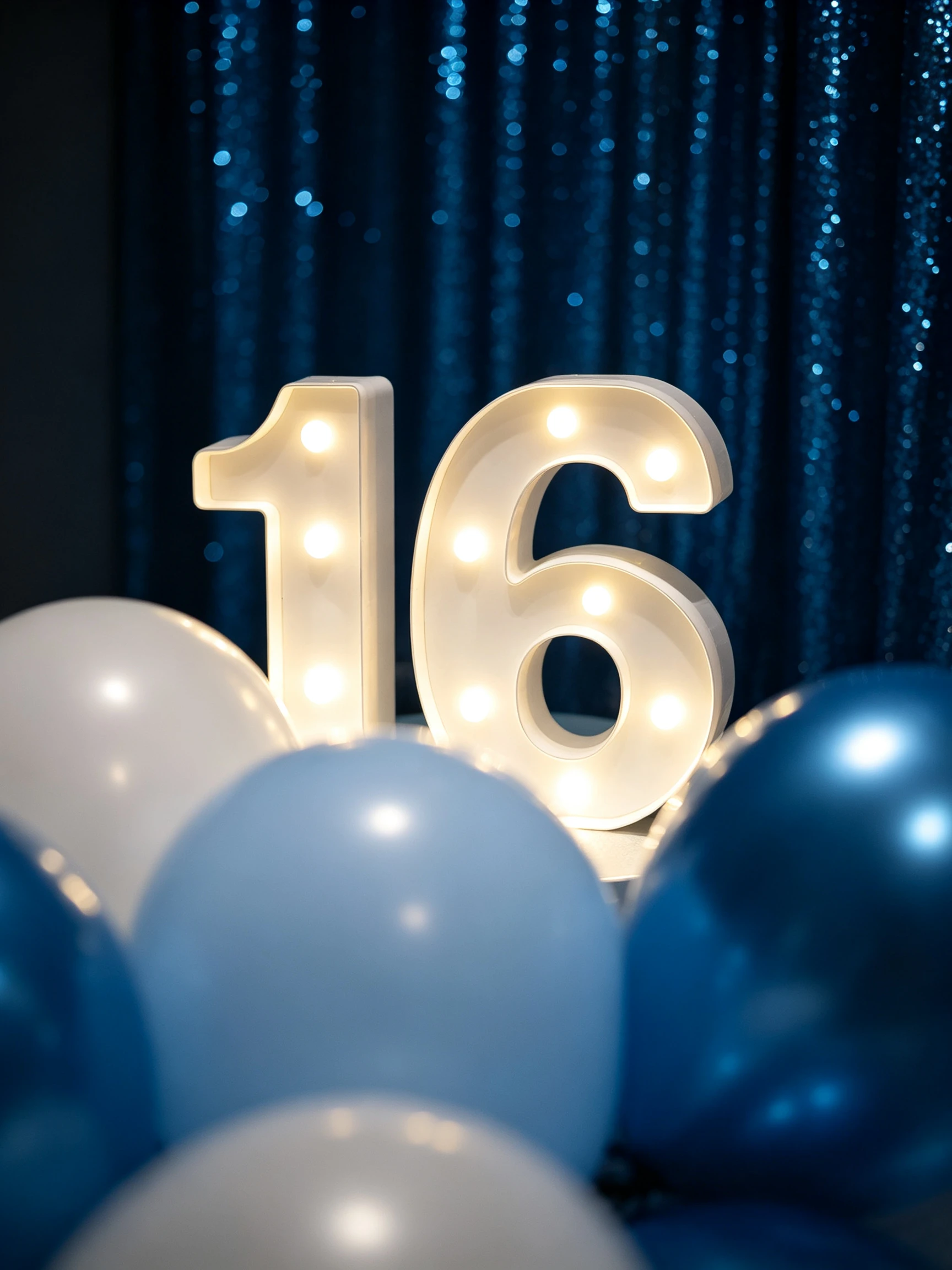 Close up of illuminated Sweet 16 number 16 marquee sign