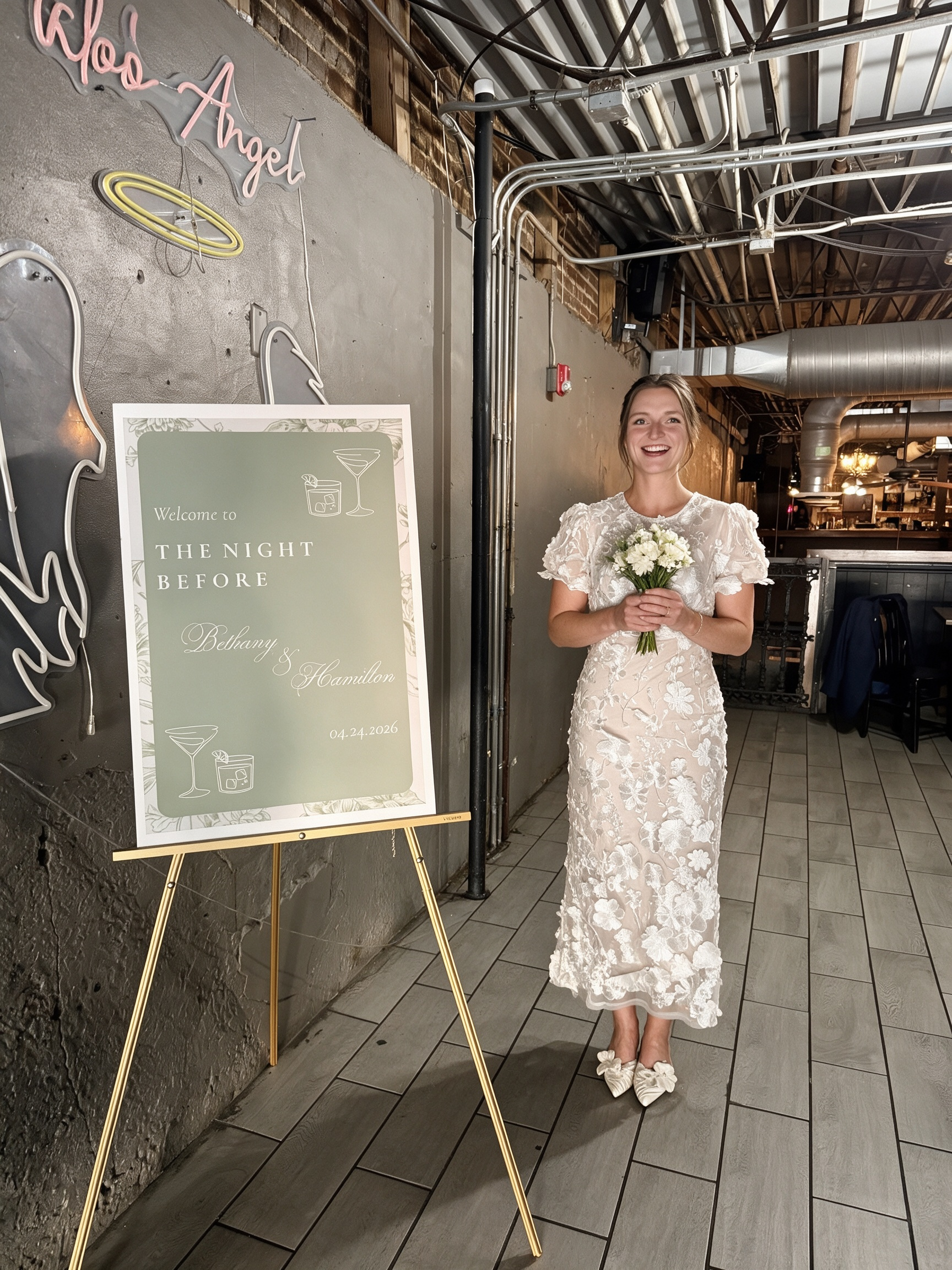 Holding a bouquet while wearing a white floral lace rehearsal dress