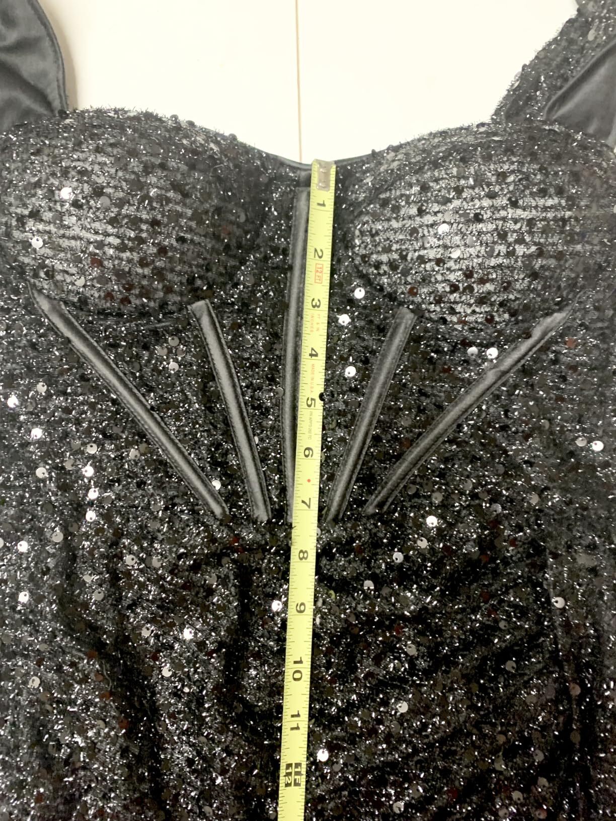 Measuring the structured boned bodice of a sequin formal gown