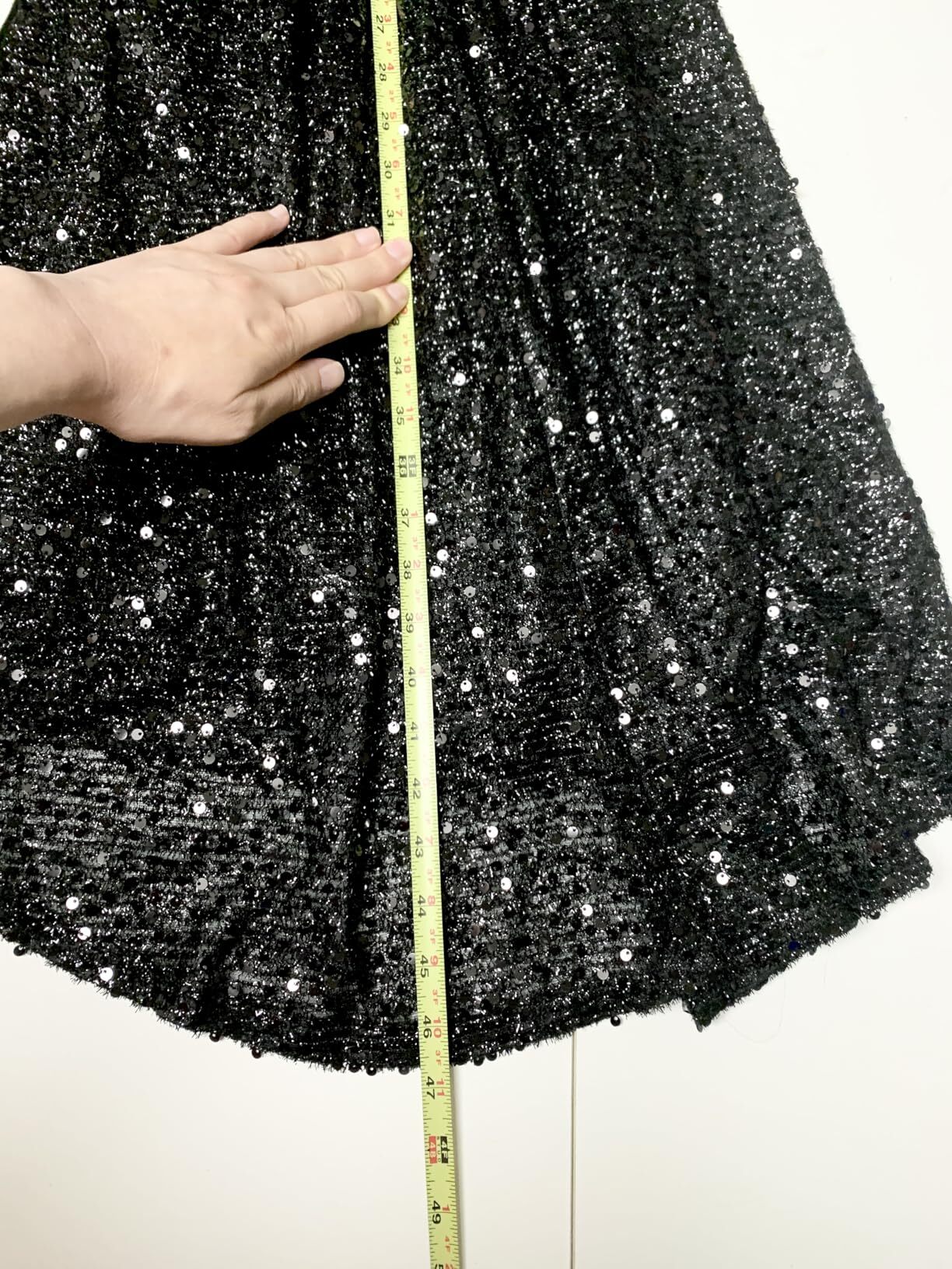 Measuring the skirt length of a black sequin mermaid prom dress
