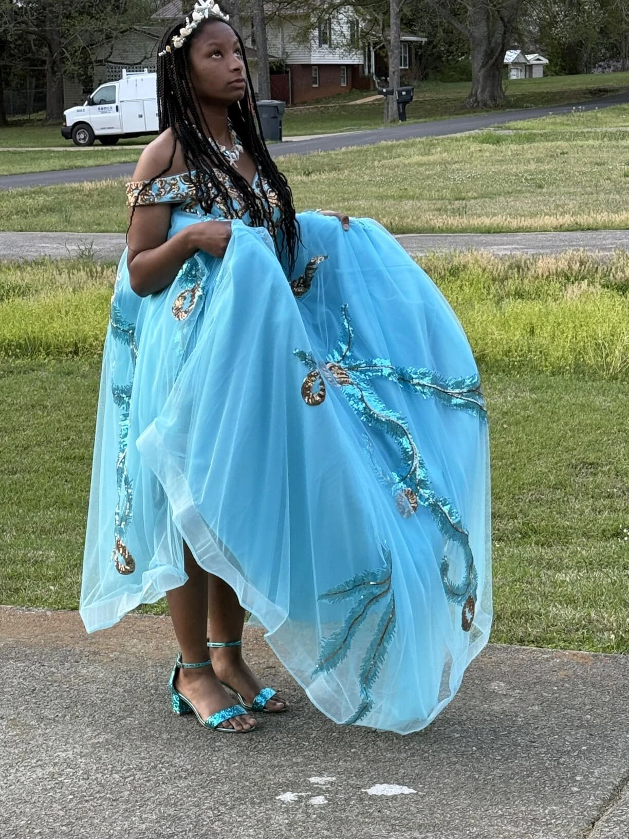 Teen wearing a turquoise formal gown during her prom experience