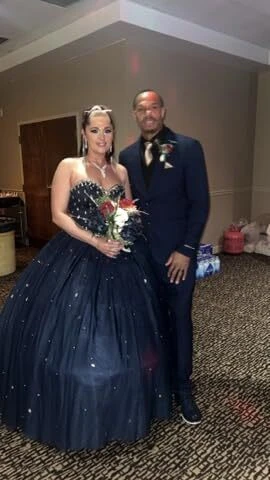Bride and groom posing together in the hotel ballroom